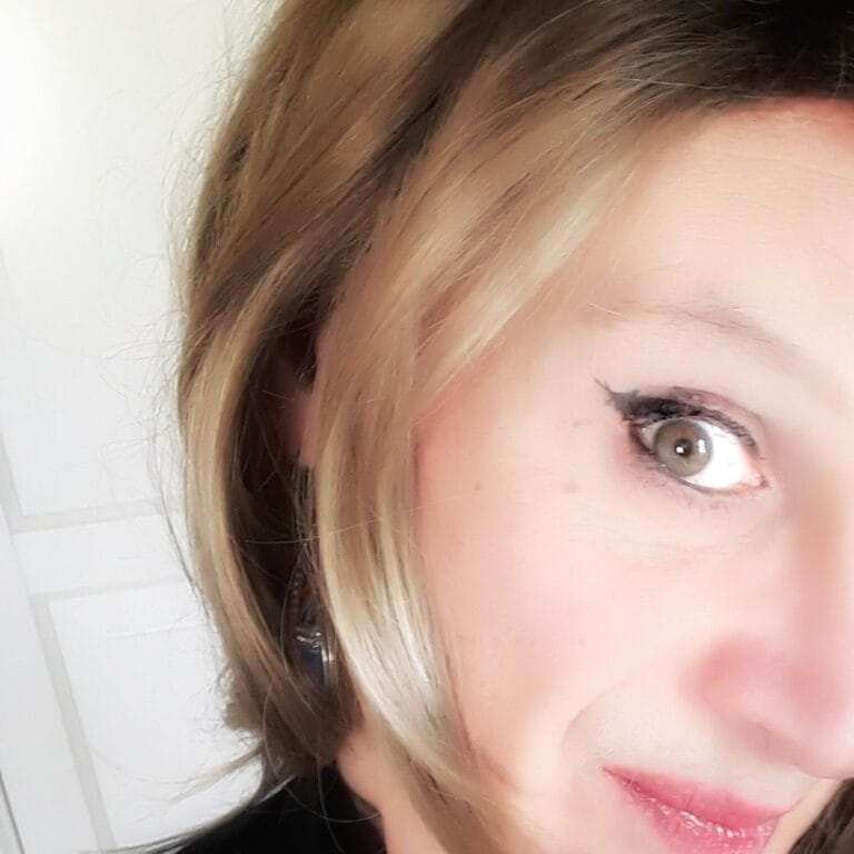 Close-up of a young person's right eye with winged eyeliner and light brown hair framing the face.